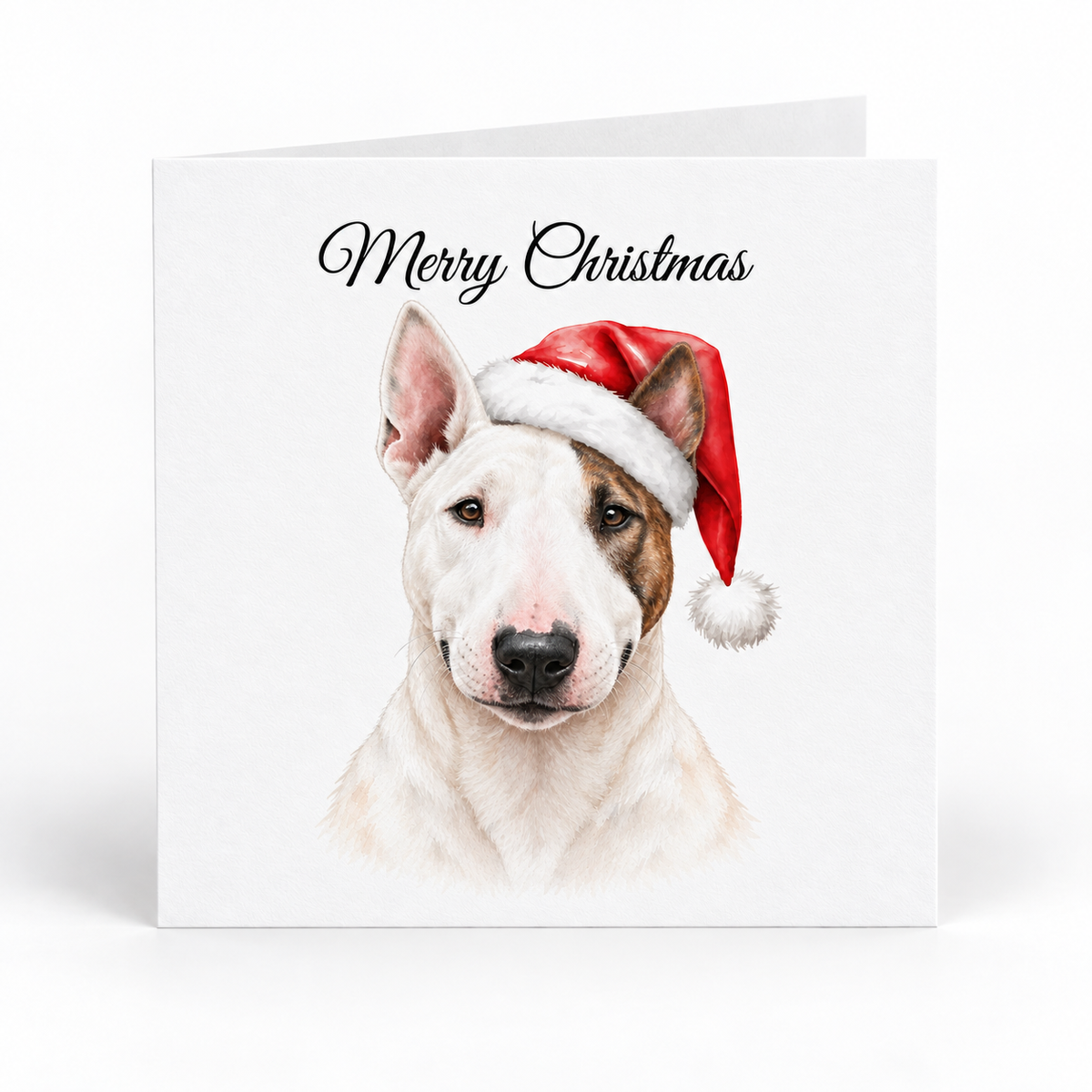 A square white Christmas greeting card with 'Merry Christmas' in black script at the top and a watercolor-style illustration of a white and brown dog wearing a red Santa hat. The card is photographed standing upright against a clean white background.