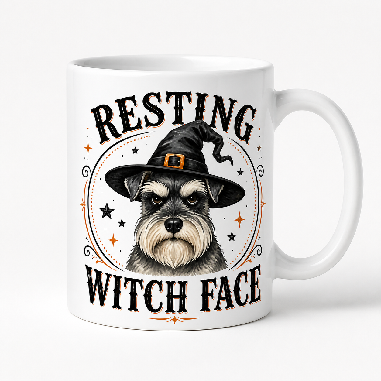 A white ceramic mug featuring a graphic of a Schnauzer dog wearing a witch hat, with the text 'RESTING WITCH FACE' in black and orange accents.