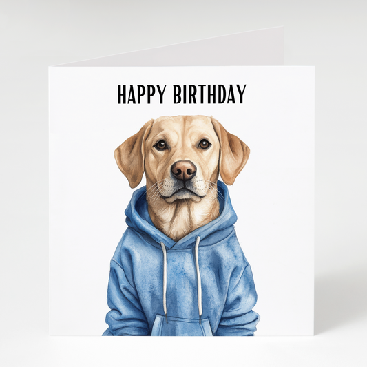 Cute Labrador Retriever wearing a blue hoodie on a colorful birthday card with birthday lettering, perfect for dog lovers and Labrador owners.