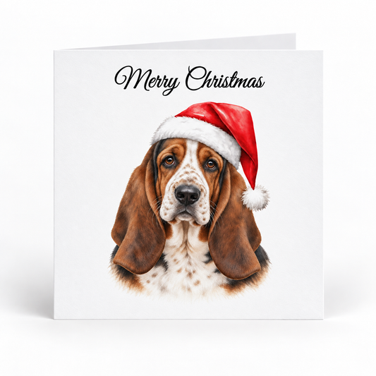 A square Christmas greeting card with a white background, featuring a painted basset hound wearing a red Santa hat and the words 'Merry Christmas' in black script at the top.