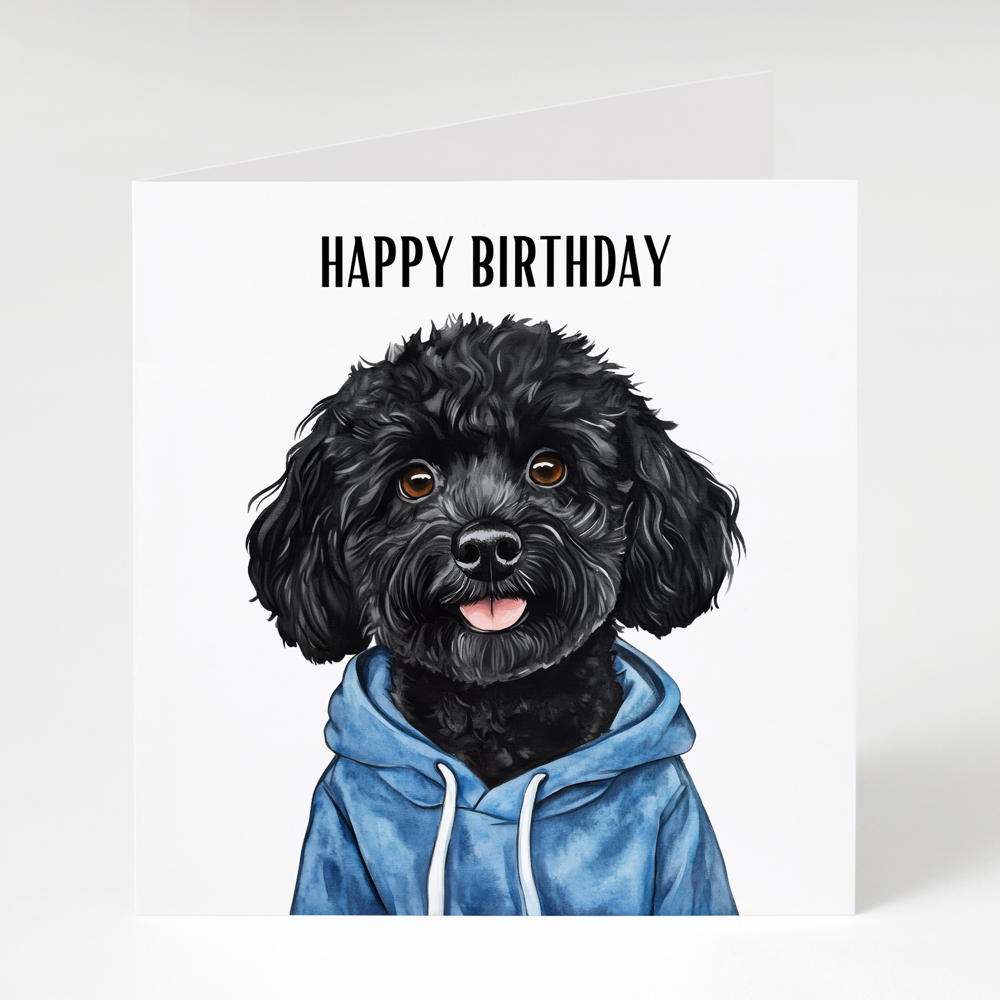 Cute Black Cockapoo wearing a hoodie on a colourful birthday card, perfect for Black Cockapoo owners, dog lovers, and birthday celebrations.