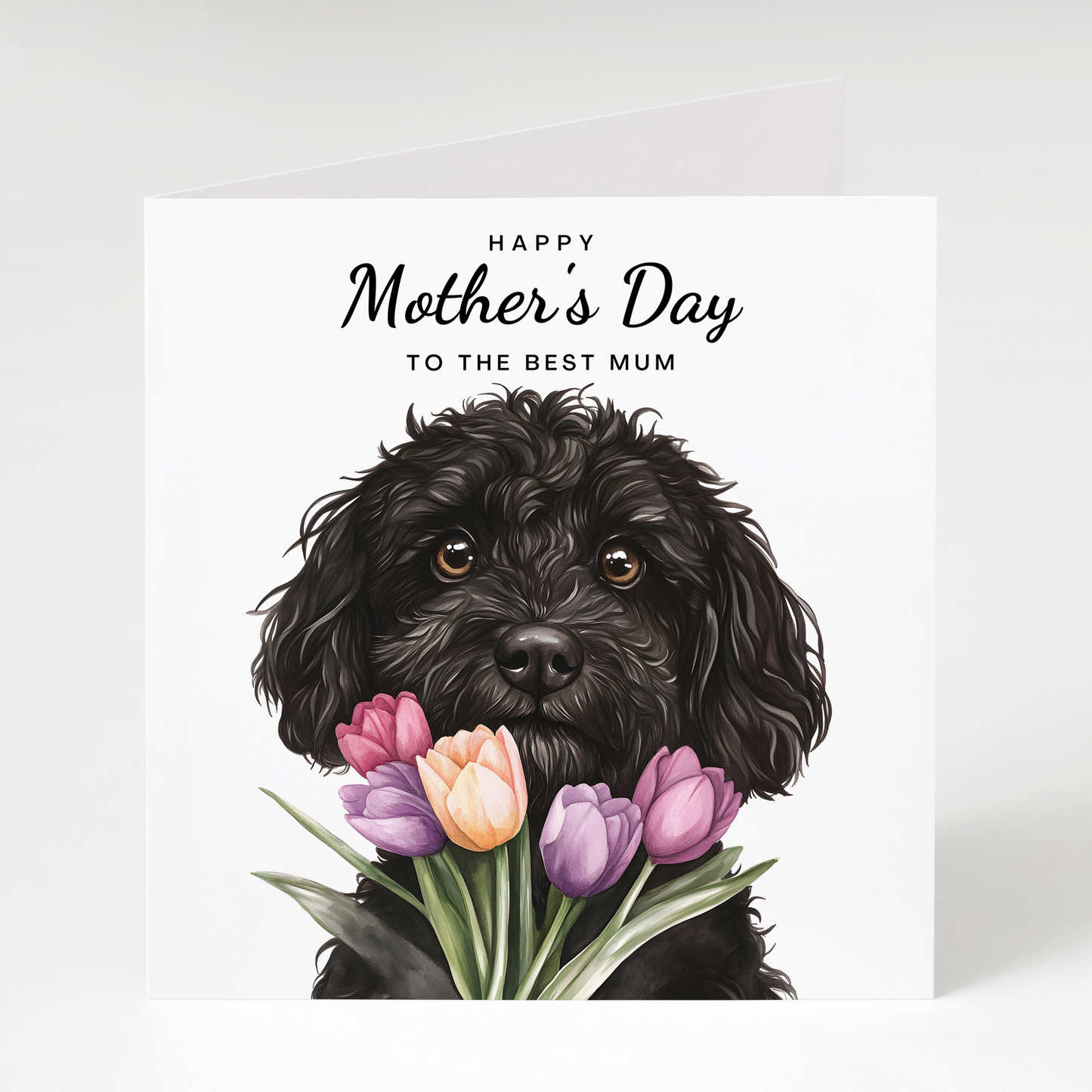 Greeting card with black cockapoo dog holding flowers and 'Happy Mother's Day to the best mum' text on a white background.
