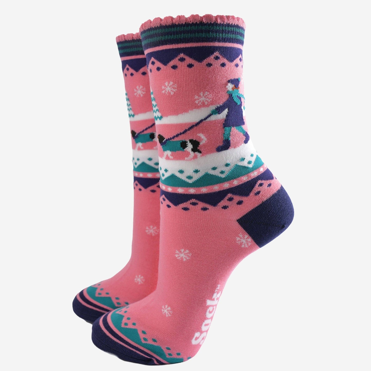 Pair of pink socks with winter-themed design on a white background